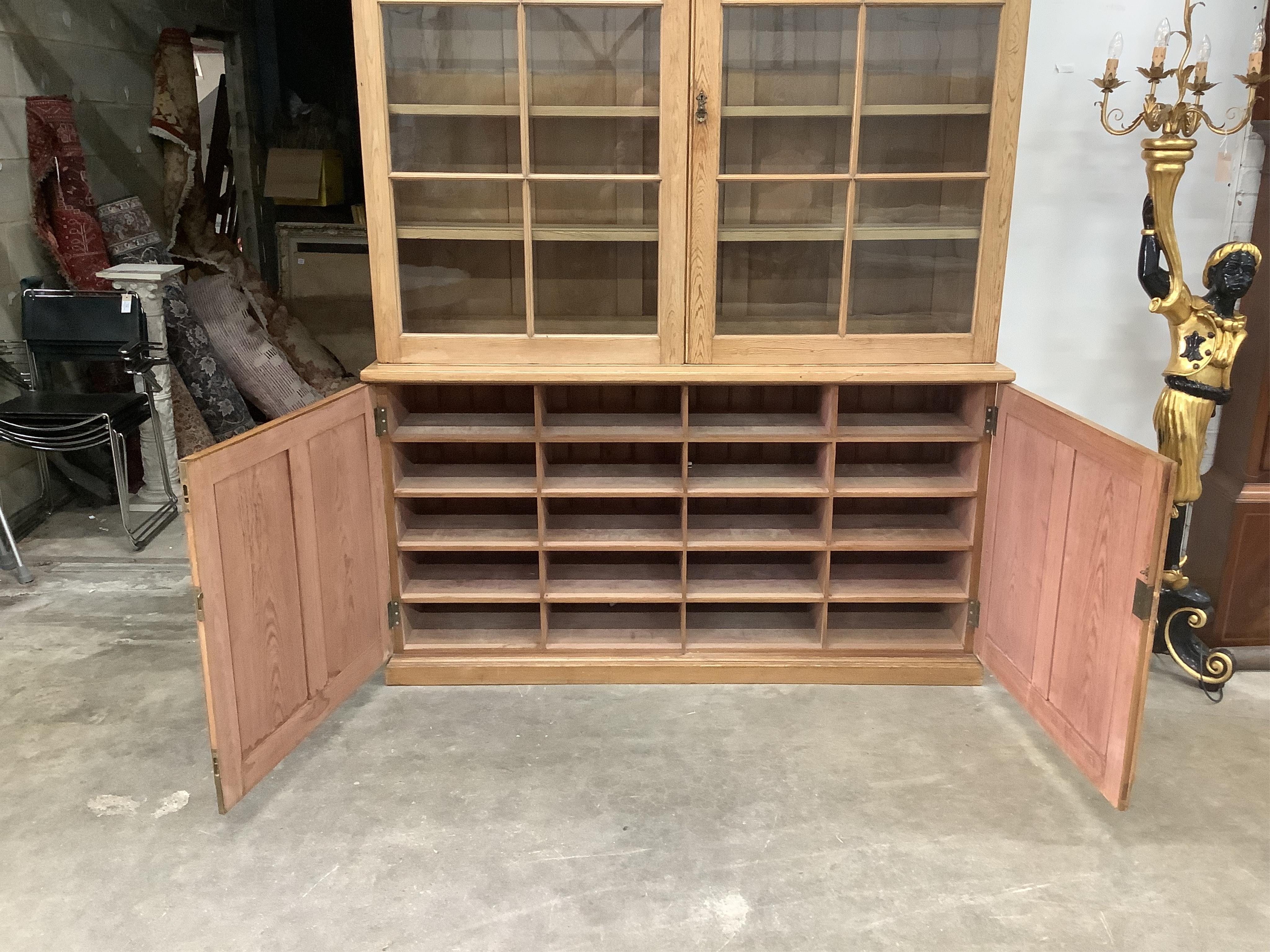 A Victorian pitch pine bookcase / cupboard with compartmented panelled base, width 168cm, depth 42cm, height 231cm. Condition - good